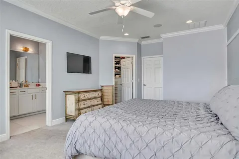 a bedroom with a large bed and a tv