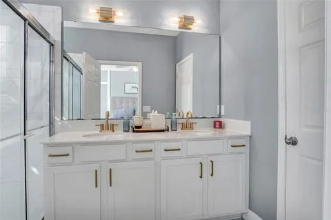 a bathroom with double sink and a mirror