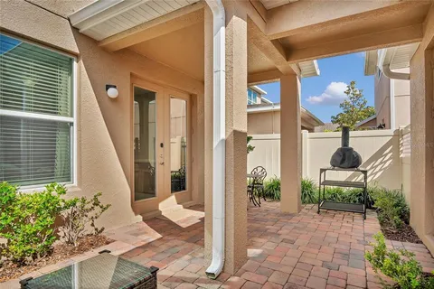 a view of a porch with chairs and potted plants
