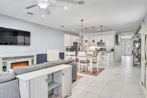 a kitchen with stainless steel appliances kitchen island granite countertop a stove top oven a sink a counter top space and cabinets