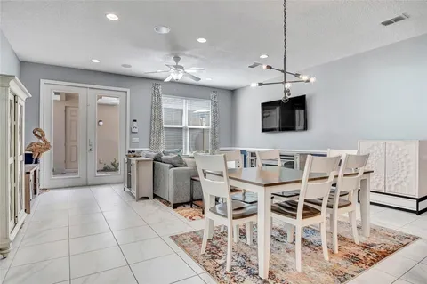 a view of a livingroom with furniture a flat screen tv and kitchen view