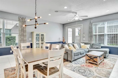 a living room with lots of furniture and a chandelier