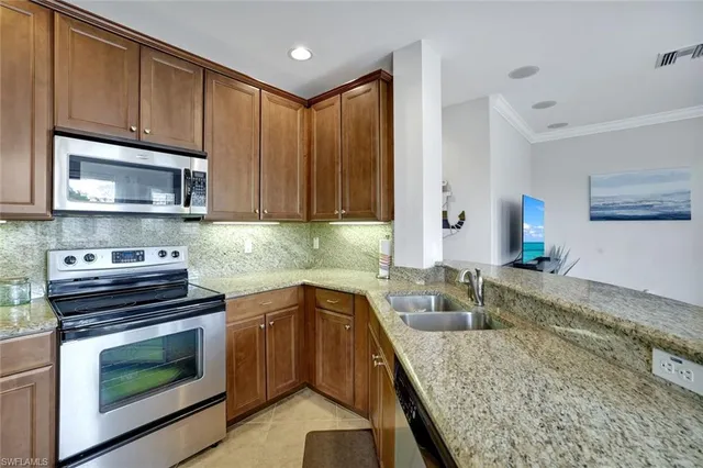 a kitchen with a sink stove and microwave
