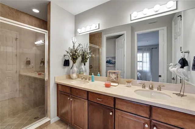 a bathroom with a sink vanity granite shower and a mirror