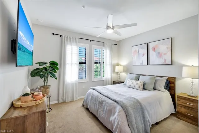 a bedroom with a bed and a potted plant