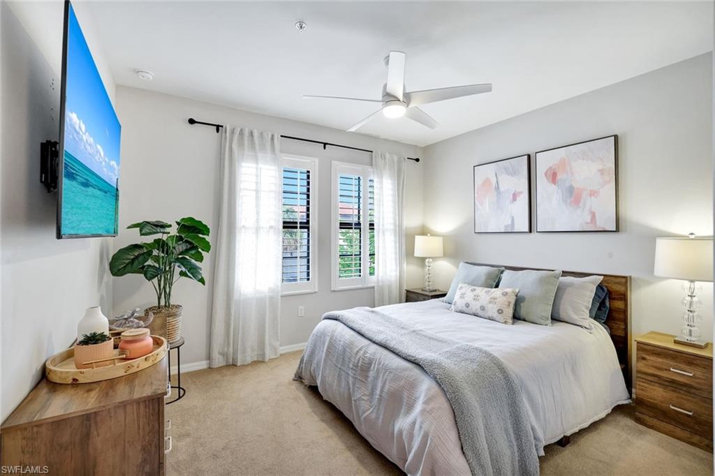 1383 Artesia Drive West, Unit 701 Naples, FL 34113 - Photo 14 of 43 a bedroom with a bed and a potted plant