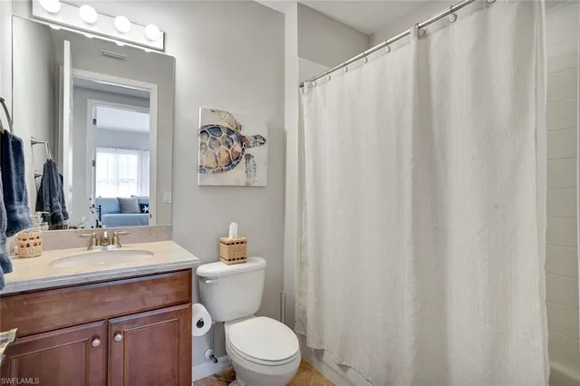 a bathroom with a toilet a sink and a mirror