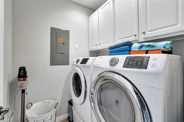a view of washer and dryer with kitchen in the background