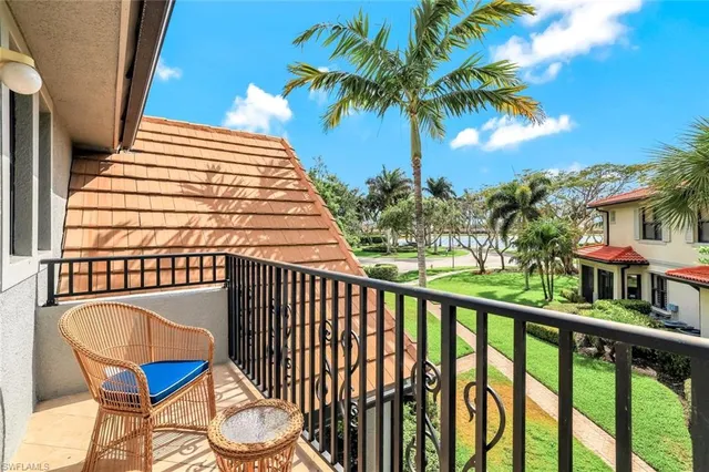 a view of a balcony with wooden floor and outdoor seating