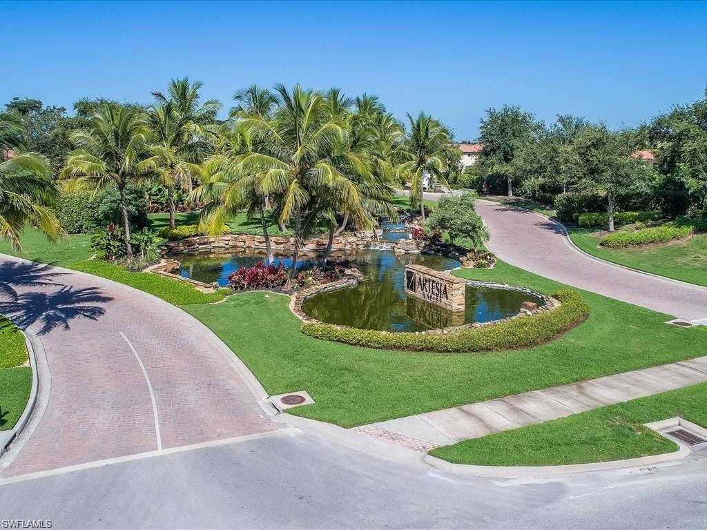 1383 Artesia Drive West, Unit 701 Naples, FL 34113 - Photo 25 of 43 a view of a swimming pool with a yard
