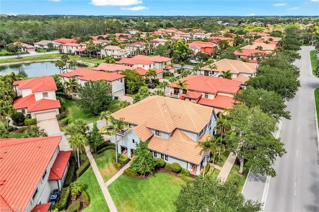 an aerial view of residential houses with outdoor space and river