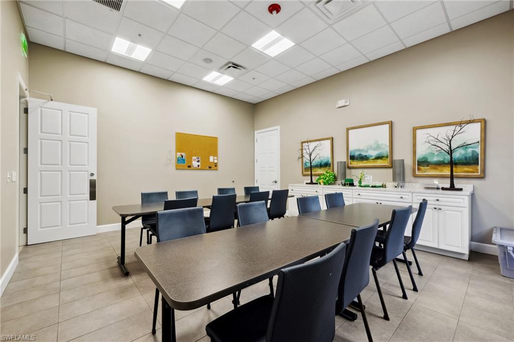 1383 Artesia Drive West, Unit 701 Naples, FL 34113 - Photo 36 of 43 a view of a dining room with furniture and wooden floor
