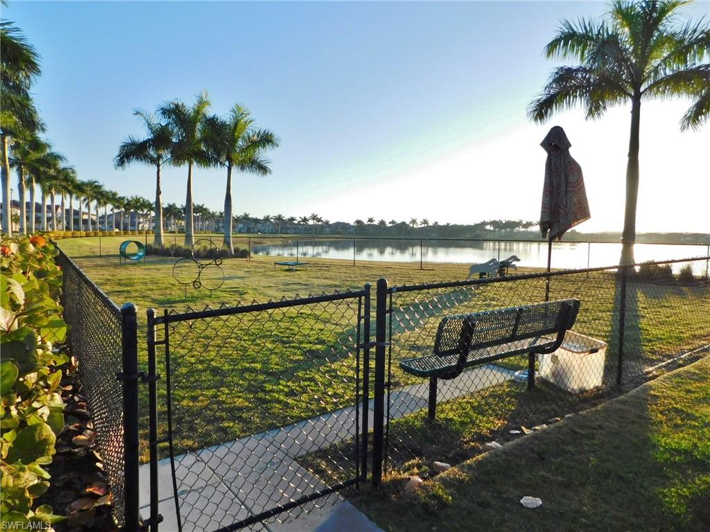 1383 Artesia Drive West, Unit 701 Naples, FL 34113 - Photo 38 of 43 a view of lake with a table and chairs