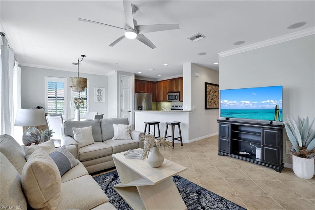 1383 Artesia Drive West, Unit 701 Naples, FL 34113 - Photo 8 of 43 a living room with furniture and a flat screen tv