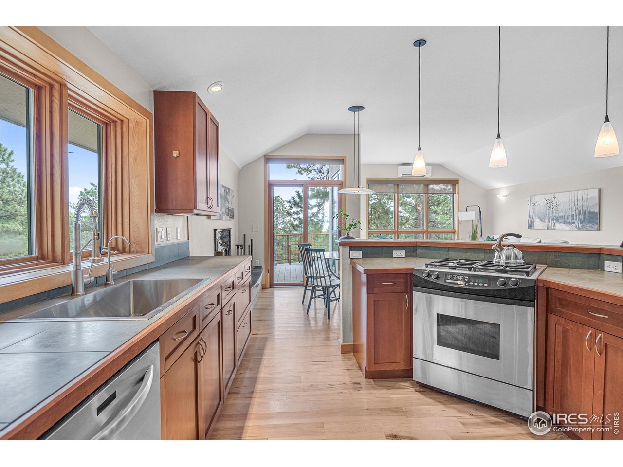 1107 Mountain Pines Road Boulder, CO 80302 - Photo 3 of 40 a kitchen with stainless steel appliances granite countertop a stove a sink and a wooden cabinets