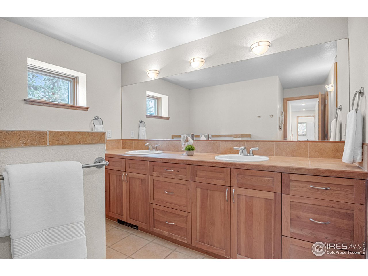 1107 Mountain Pines Road Boulder, CO 80302 - Photo 34 of 40 a bathroom with a granite countertop sink a large mirror and a bathtub