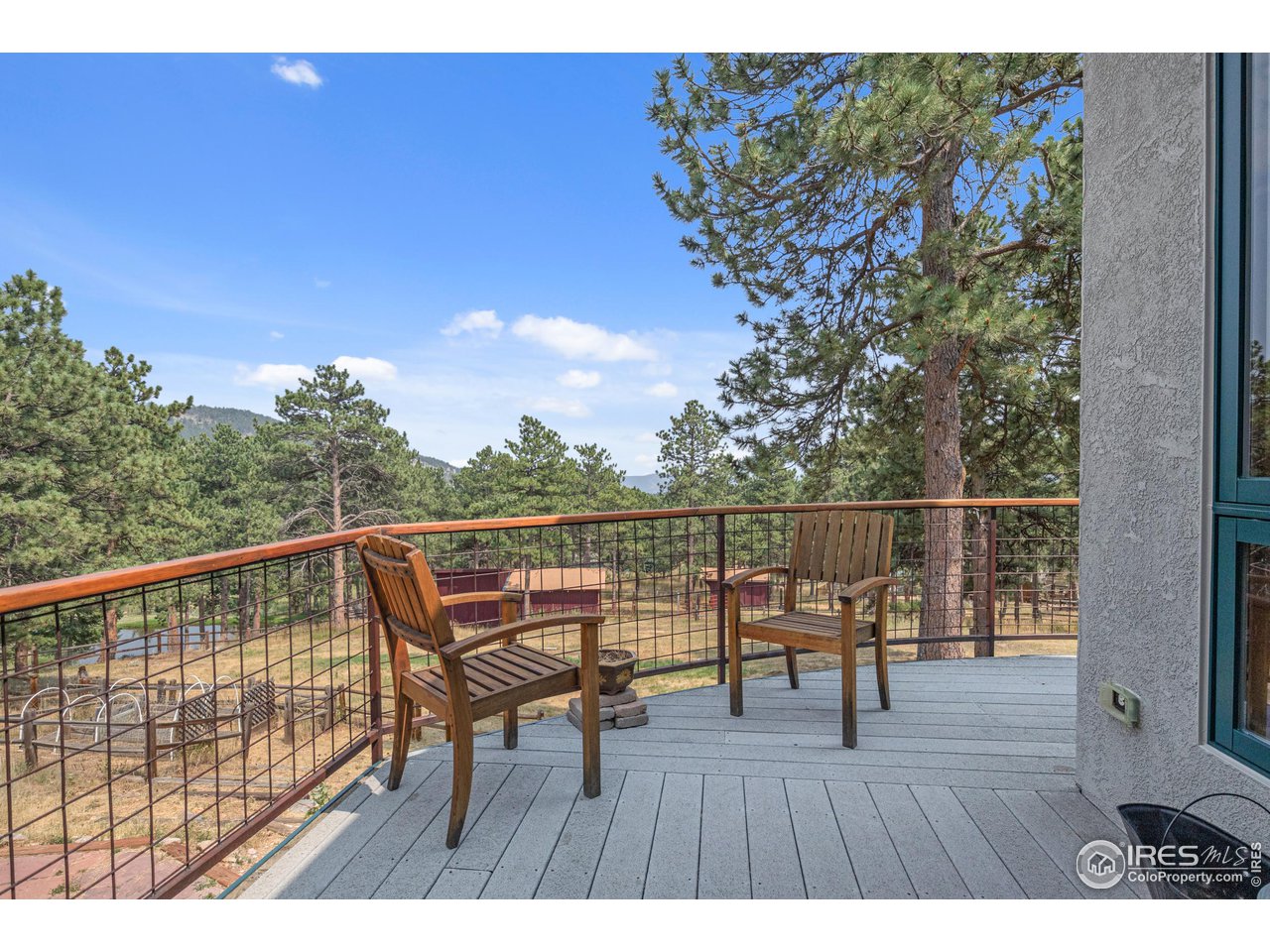 1107 Mountain Pines Road Boulder, CO 80302 - Photo 10 of 40 a balcony with wooden floor table and chairs
