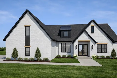 a front view of a house with a yard and green space