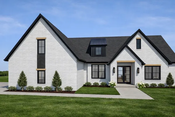 a front view of a house with a yard and green space