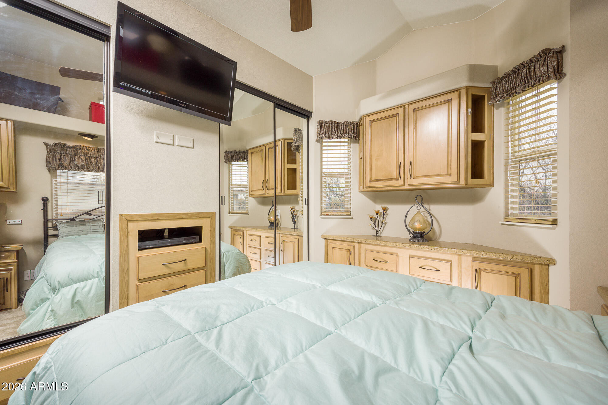 1030 Barrel Cactus Ridge, Unit 39 Benson, AZ 85602 - Photo 11 of 36 a bedroom with a bed dresser and a flat tv screen