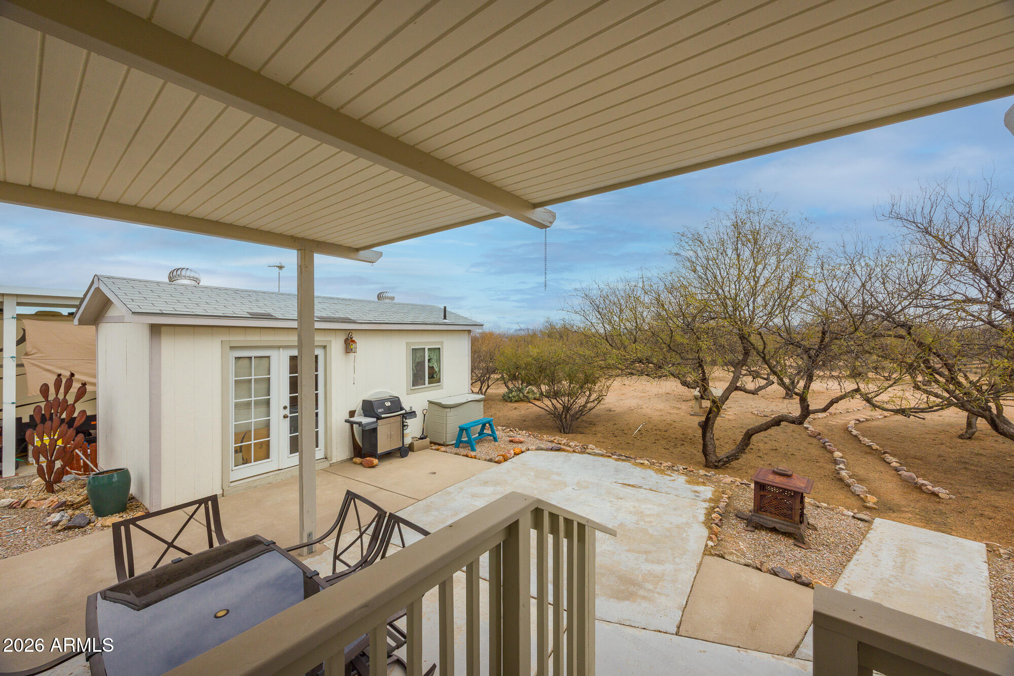 1030 Barrel Cactus Ridge, Unit 39 Benson, AZ 85602 - Photo 14 of 36 a view of a patio with table and chairs under an umbrella