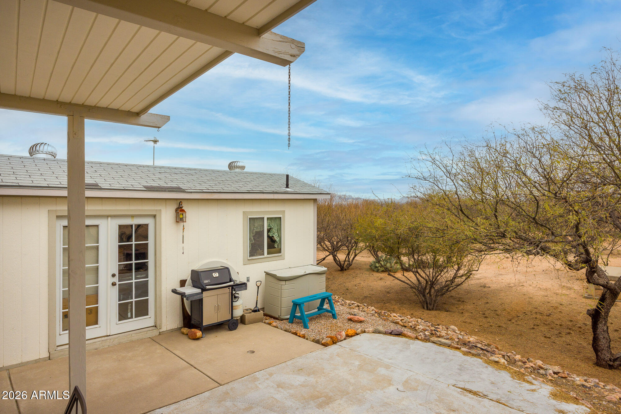 1030 Barrel Cactus Ridge, Unit 39 Benson, AZ 85602 - Photo 15 of 36 a view of a patio with table and chairs under an umbrella
