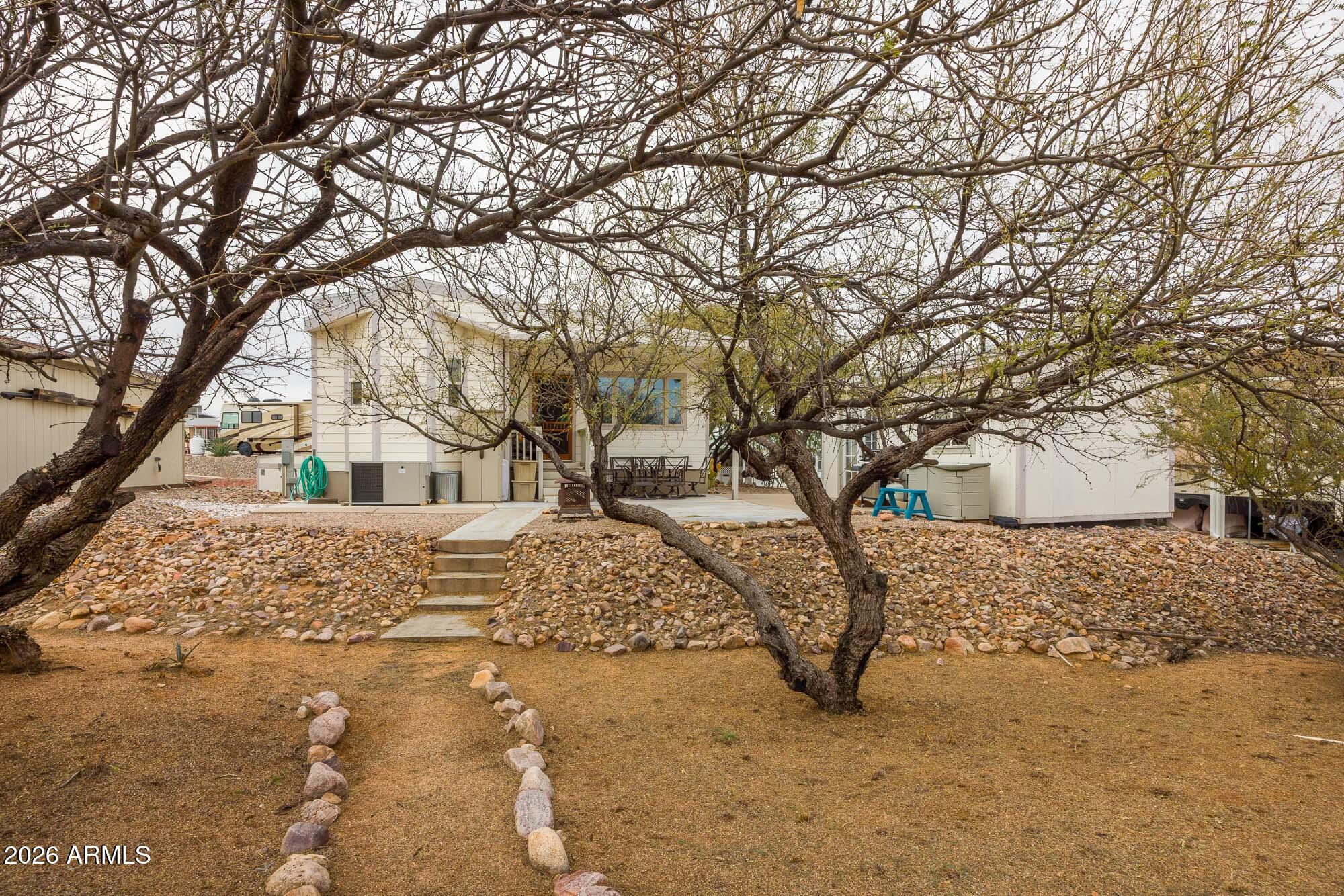 1030 Barrel Cactus Ridge, Unit 39 Benson, AZ 85602 - Photo 21 of 36 a view of a yard covered with snow in front of house