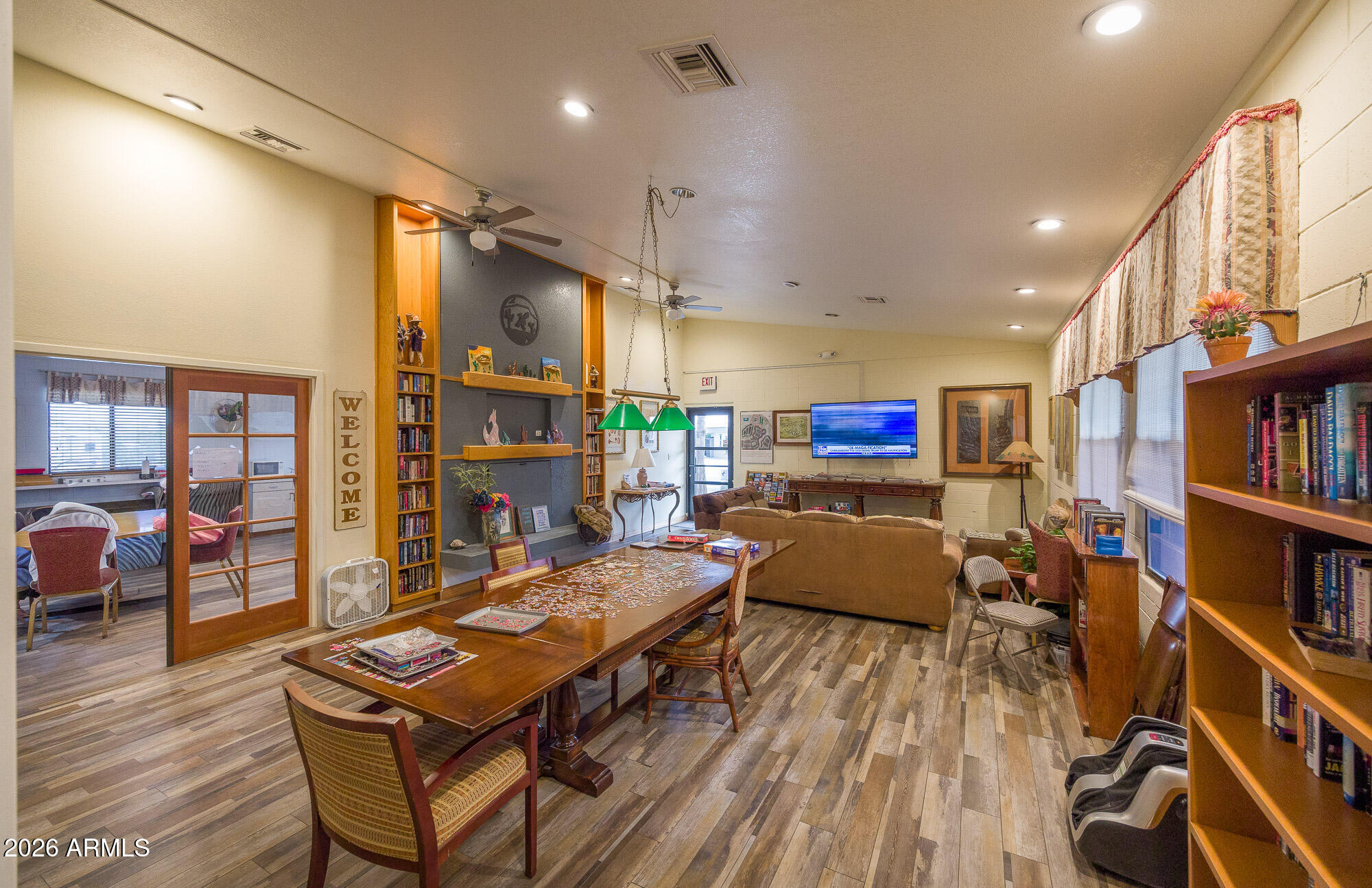 1030 Barrel Cactus Ridge, Unit 39 Benson, AZ 85602 - Photo 29 of 36 a living room with furniture a flat screen tv and a book shelf