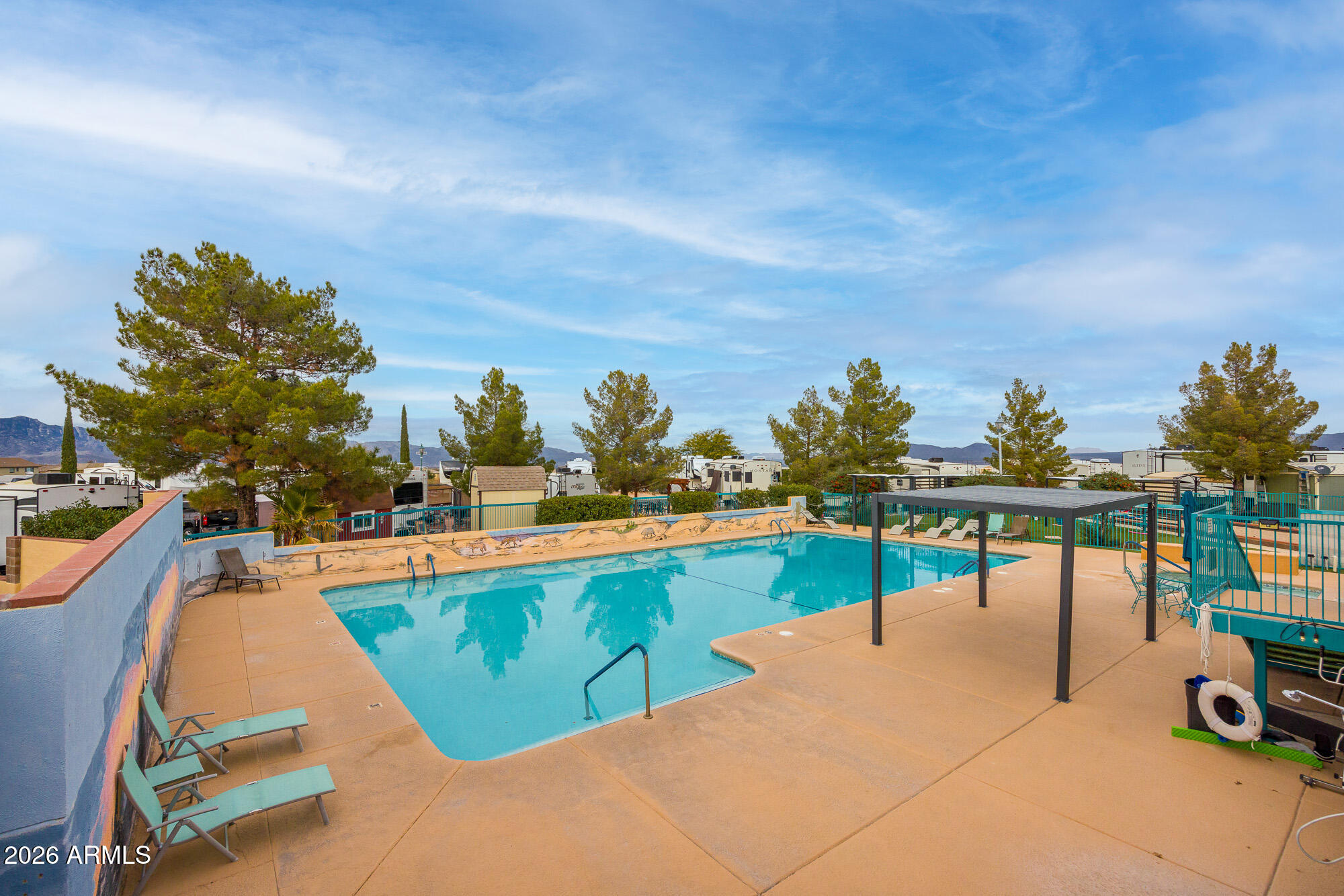 1030 Barrel Cactus Ridge, Unit 39 Benson, AZ 85602 - Photo 31 of 36 a view of a swimming pool with a lounge chair