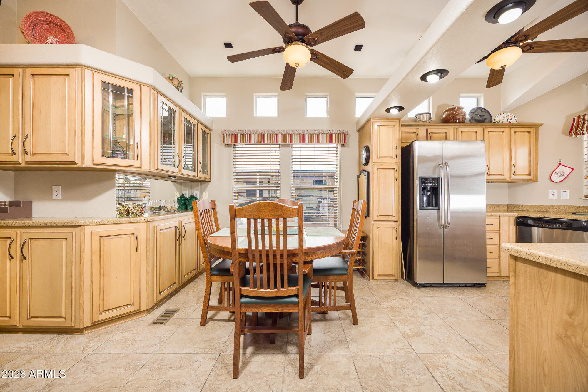 1030 Barrel Cactus Ridge, Unit 39 Benson, AZ 85602 - Photo 5 of 36 a kitchen with stainless steel appliances kitchen island granite countertop a refrigerator a stove a sink with a dining table and chairs
