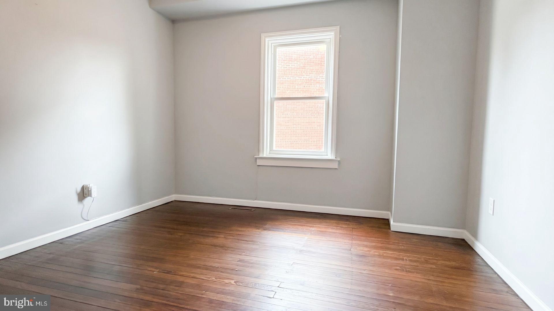 154 Andrew Street Hamilton, NJ 08610 - Photo 12 of 29 an empty room with wooden floor and windows