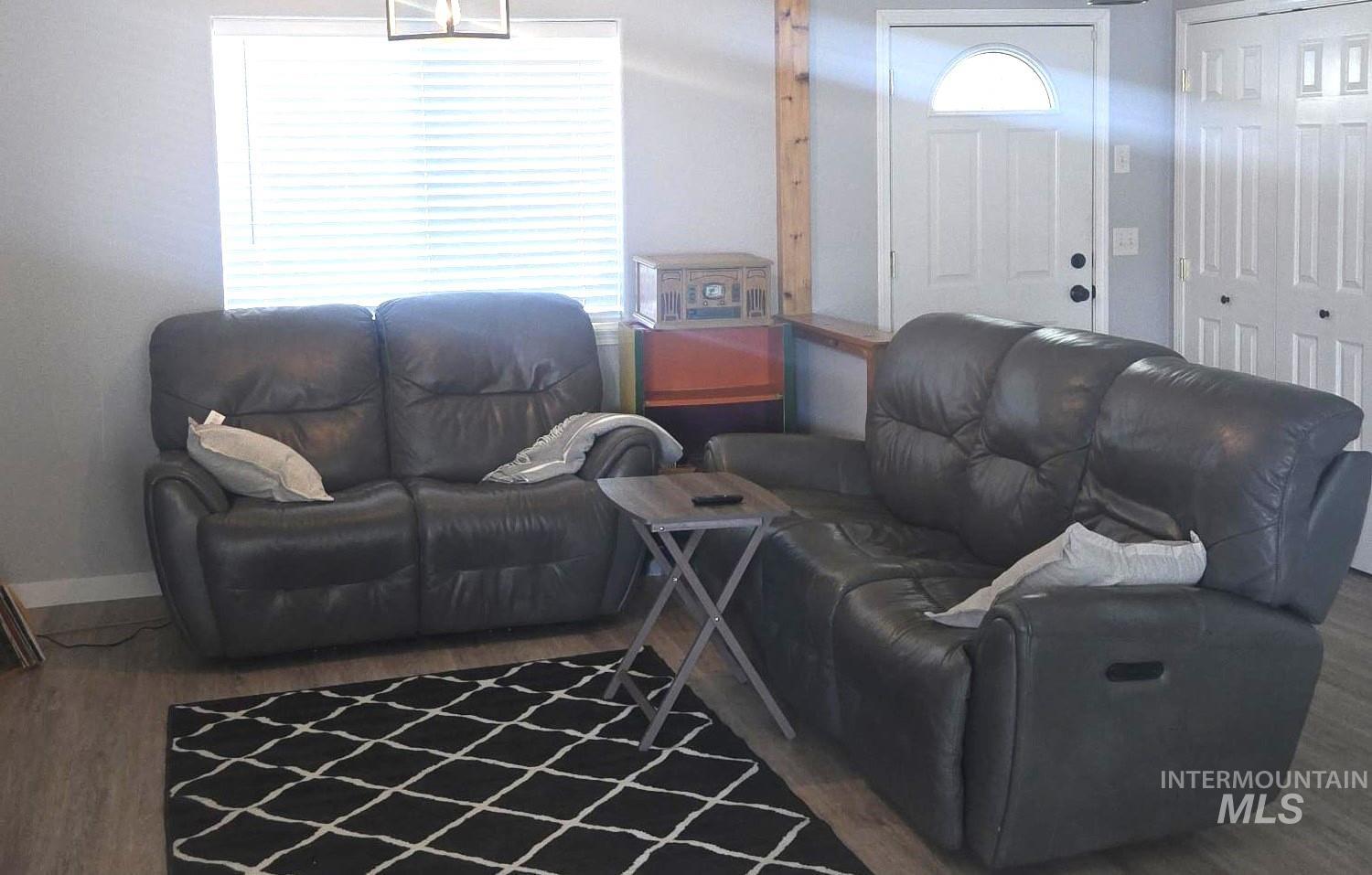 2480 West 9th Street Weiser, ID 83672 - Photo 2 of 17 Living space featuring light gray walls, wood-finish flooring, and a window with horizontal blinds