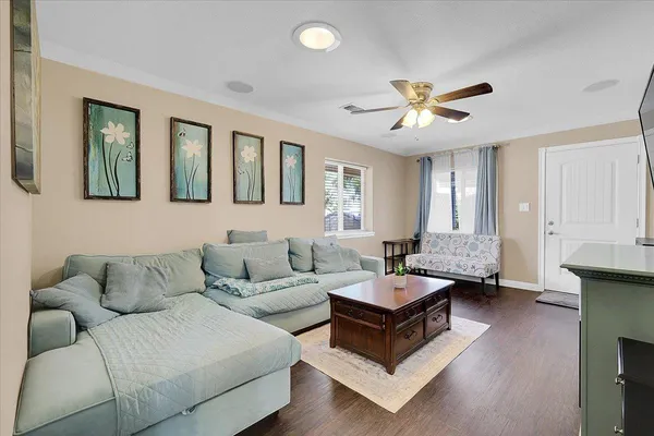 a living room with a bed furniture and a large window