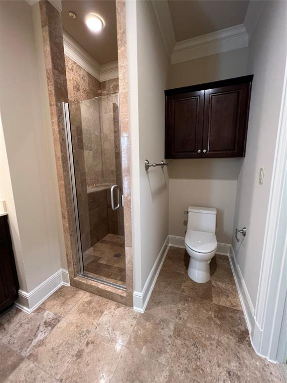 6525 Bandera Avenue, Unit 2B Dallas, TX 75225 - Photo 13 of 24 a bathroom with a toilet a sink and a shower