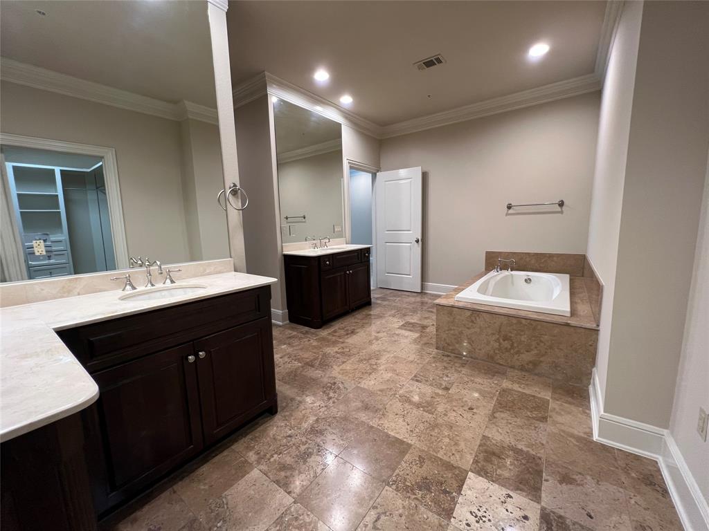 6525 Bandera Avenue, Unit 2B Dallas, TX 75225 - Photo 18 of 24 a spacious bathroom with a sink a toilet and mirror