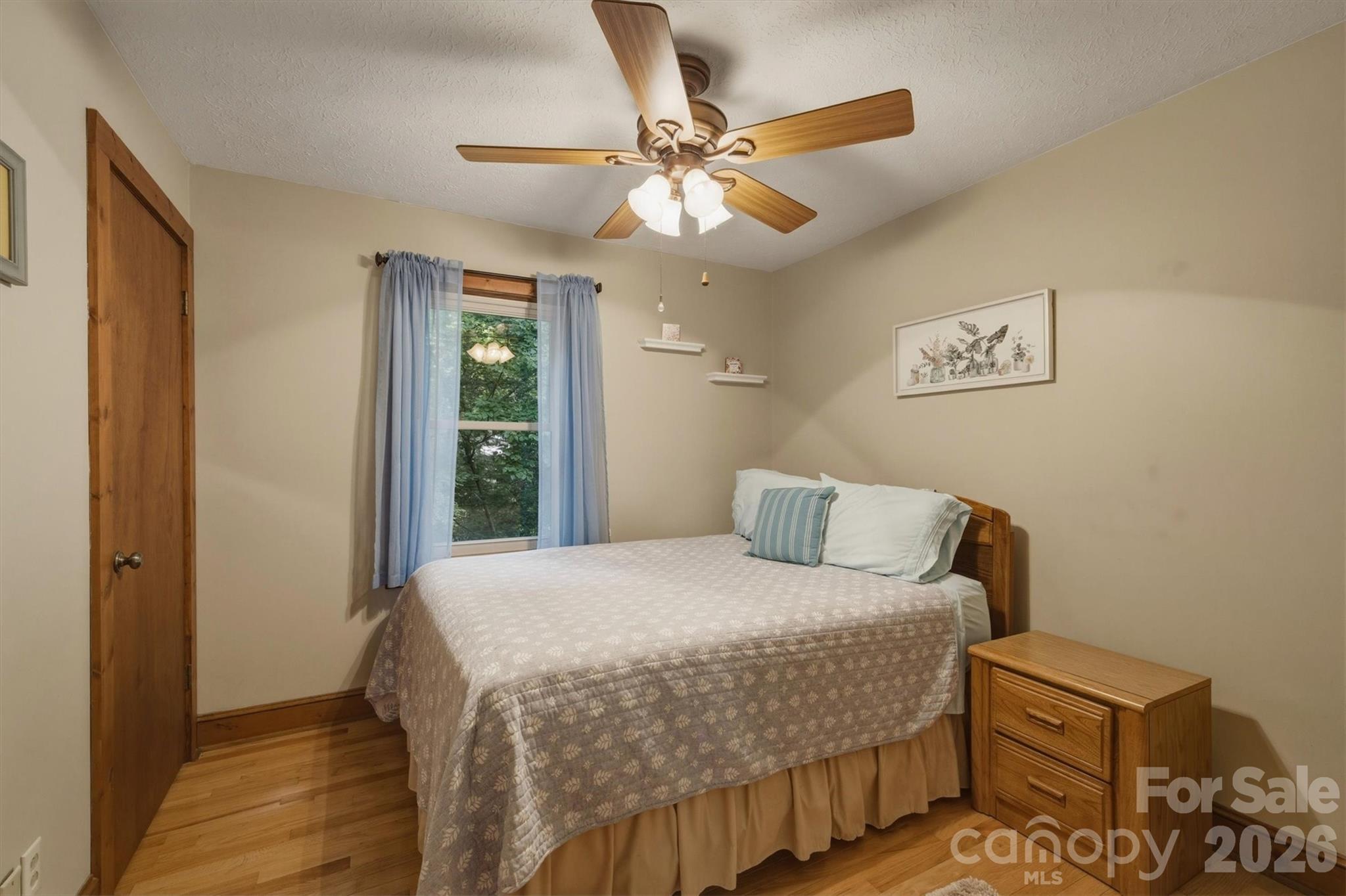 3432 Ridgewood Drive Morganton, NC 28655 - Photo 21 of 36 a bedroom with a bed and a chandelier