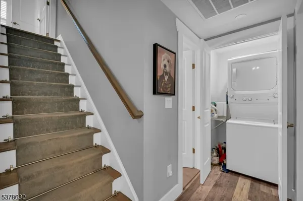 a view of entryway with stairs and wooden floor