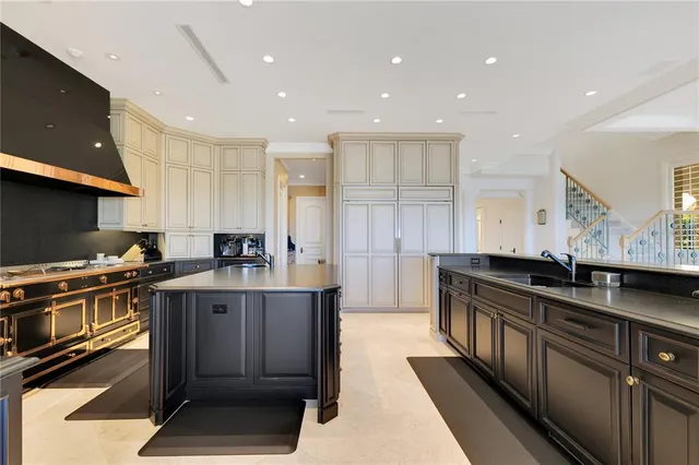 a kitchen with stainless steel appliances granite countertop a sink a stove and a refrigerator