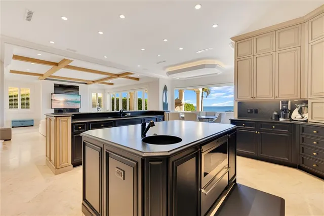 a kitchen with stainless steel appliances kitchen island granite countertop a stove a sink and a refrigerator
