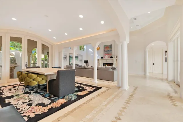 a spacious bedroom with a large bed and a chandelier