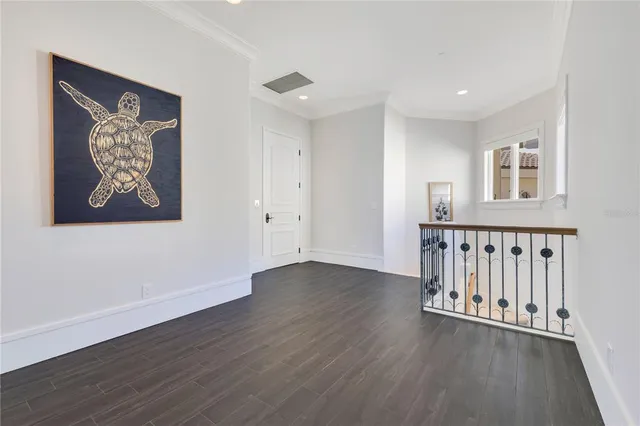 a large white room with a white cabinet and a chair