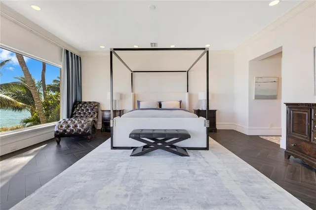 a bedroom with a large bed and a chandelier