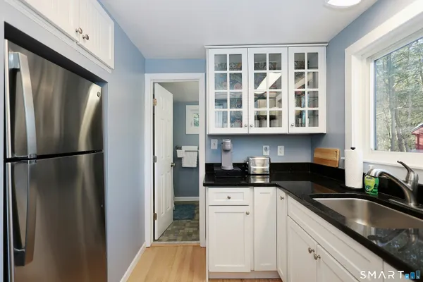 a kitchen with stainless steel appliances granite countertop a refrigerator and a sink