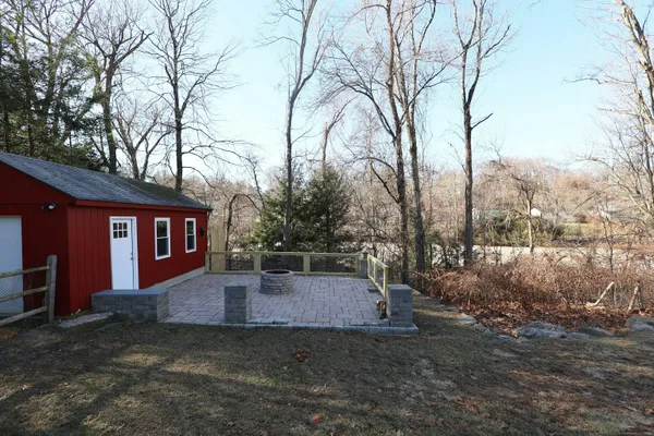a view of a backyard with large trees