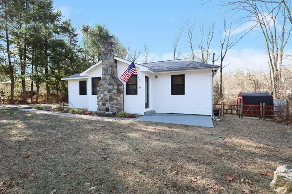 a view of a house with a yard and garage