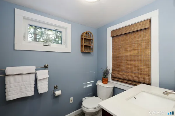 a bathroom with a toilet sink and mirror