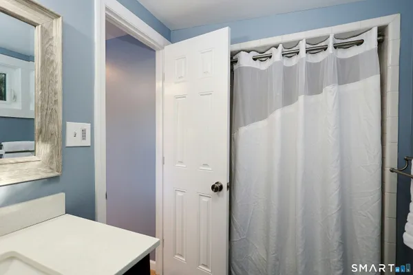 a bathroom with a shower and a curtain