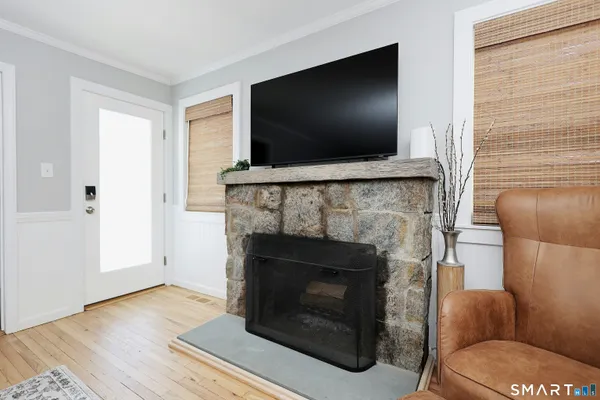 a living room with a fireplace and a flat screen tv