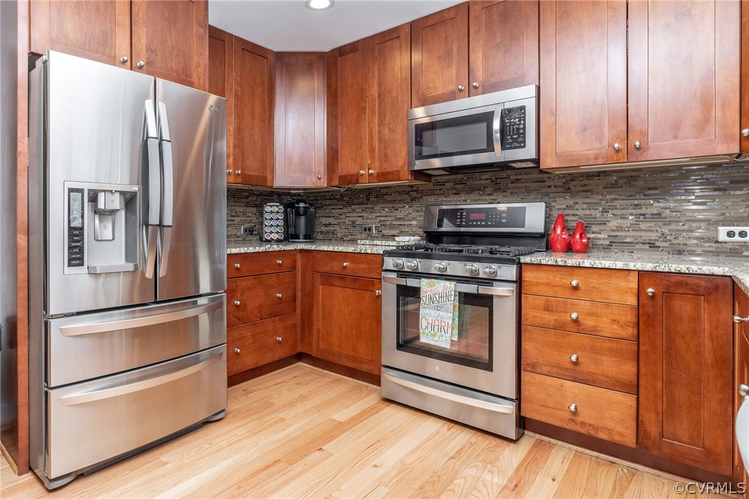 13331 Queensgate Road Midlothian, VA 23114 - Photo 16 of 46 a kitchen with stainless steel appliances granite countertop a refrigerator stove and sink with wooden cabinets