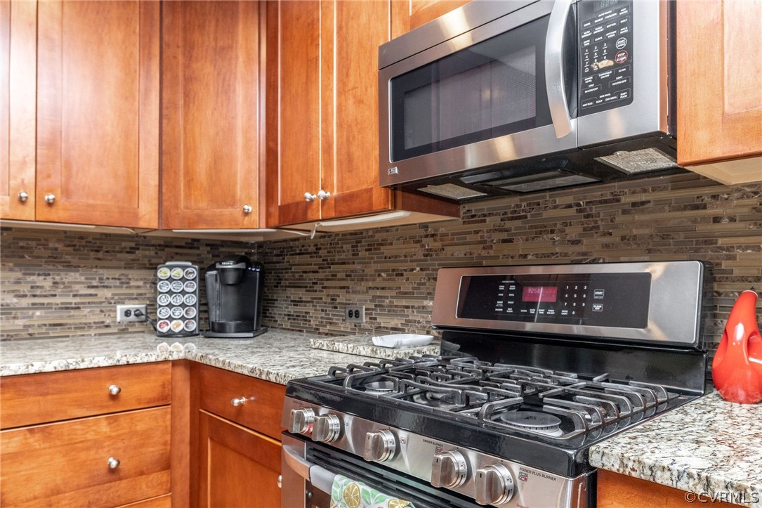 13331 Queensgate Road Midlothian, VA 23114 - Photo 19 of 46 a kitchen with stainless steel appliances granite countertop a stove a sink and a microwave